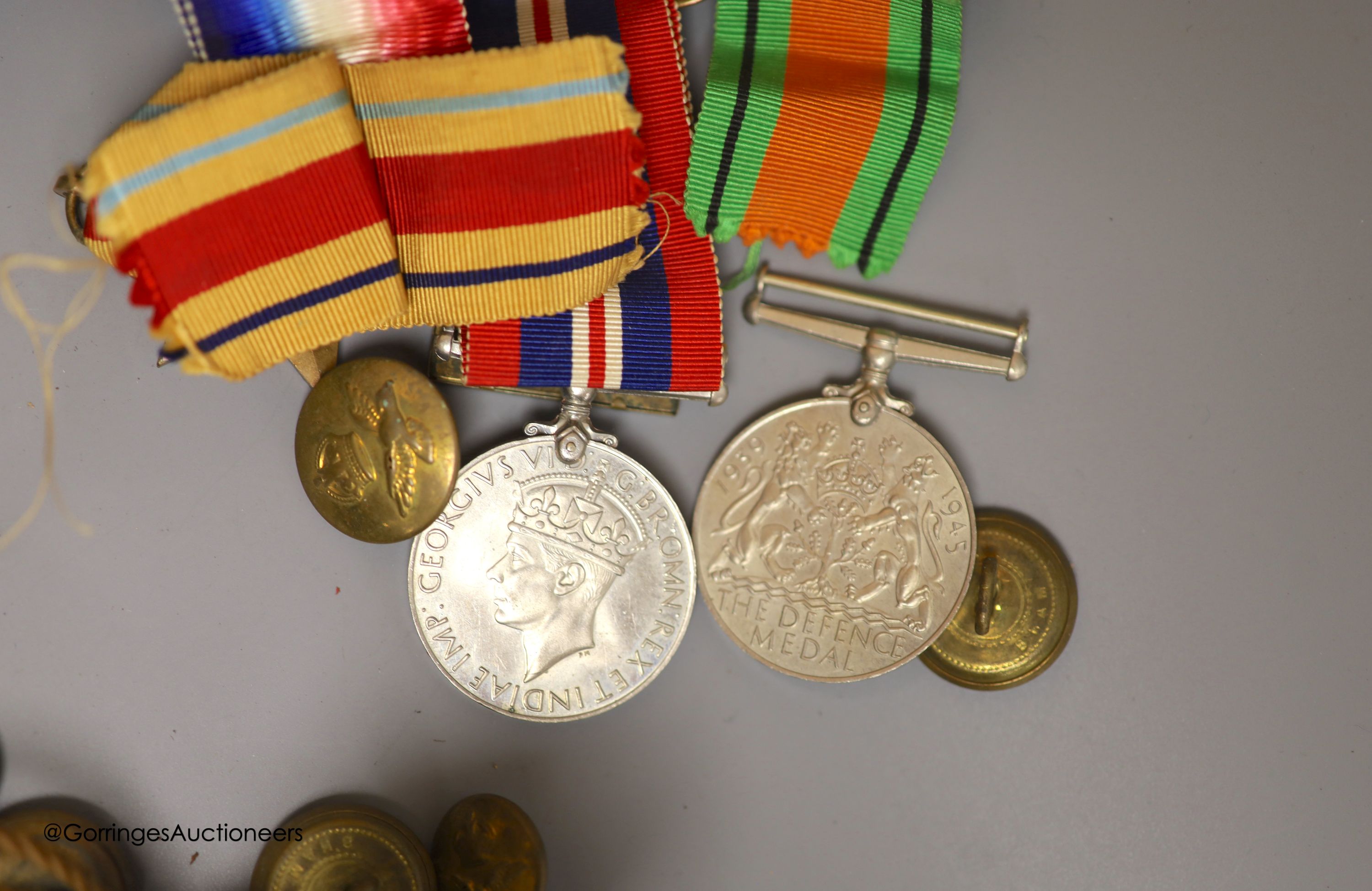 A leather cased flask and cups, various WWI and WWII medals, binoculars and a fishing reel